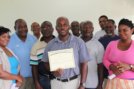 President of the New River Farmers Development Cooperative Society Limited Mr. Marcel Hanley shows off the Certificate of Registration from the Department of Cooperatives. He is surrounded by members of the new Copoperative